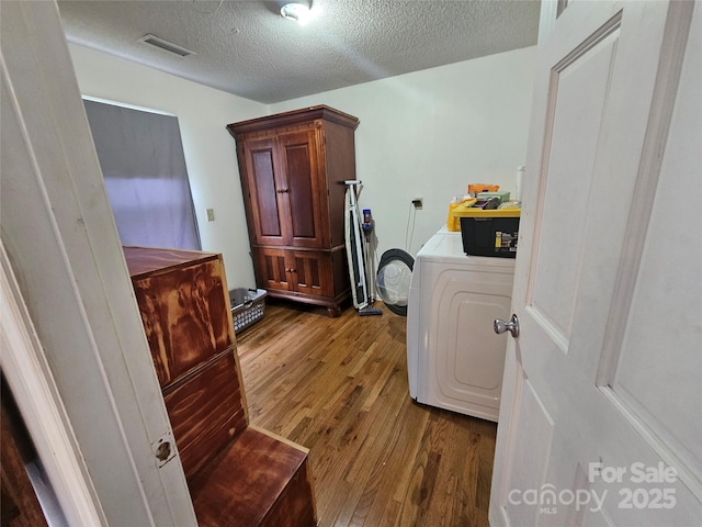 180 Vance Price Rd, Forest City, NC 28043 - laundry room with washer / clothes dryer, dark wood-type flooring, and a textured ceiling