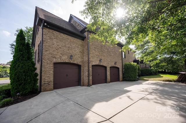 1500 Lookout Cir, Waxhaw, NC 28173 - view of home's exterior with concrete driveway, a garage, and brick siding