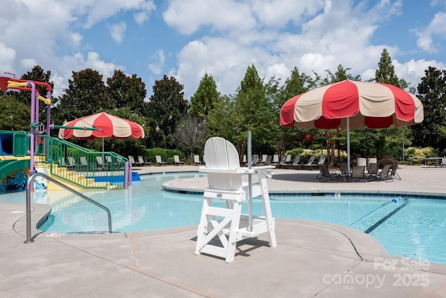 1500 Lookout Cir, Waxhaw, NC 28173 - community pool with a water slide, a patio, and a water play area