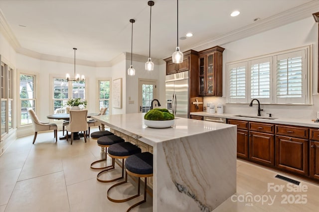 1500 Lookout Cir, Waxhaw, NC 28173 - kitchen with appliances with stainless steel finishes, a kitchen breakfast bar, plenty of natural light, a chandelier, and recessed lighting