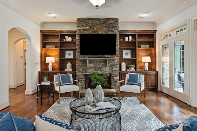 1500 Lookout Cir, Waxhaw, NC 28173 - living area with crown molding, arched walkways, a fireplace, and wood finished floors