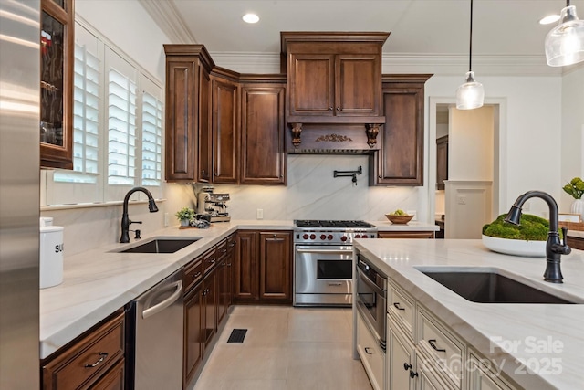1500 Lookout Cir, Waxhaw, NC 28173 - kitchen with stainless steel appliances, light stone counters, hanging light fixtures, ornamental molding, and recessed lighting
