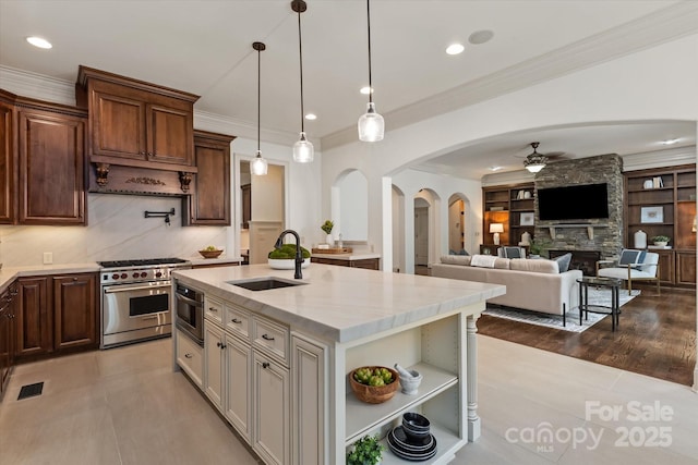 1500 Lookout Cir, Waxhaw, NC 28173 - kitchen with designer range, a ceiling fan, arched walkways, crown molding, and decorative light fixtures