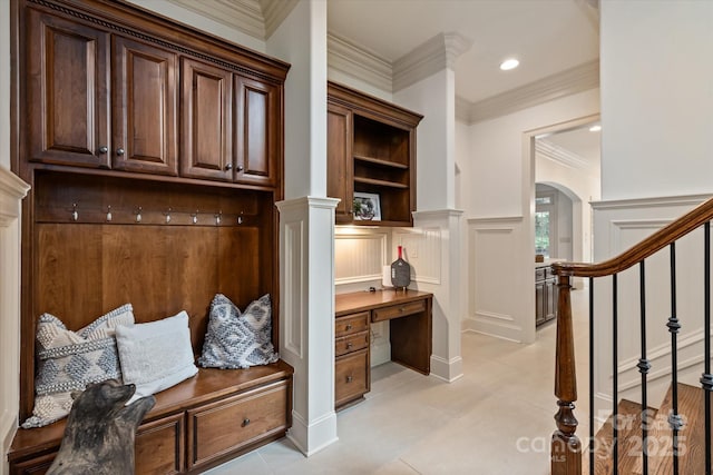 1500 Lookout Cir, Waxhaw, NC 28173 - mudroom with arched walkways, built in desk, ornamental molding, light tile patterned floors, and recessed lighting
