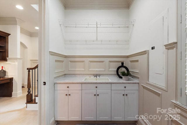 1500 Lookout Cir, Waxhaw, NC 28173 - bar area with a decorative wall, crown molding, wainscoting, and stairway
