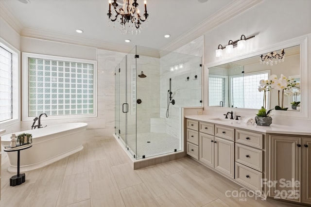 1500 Lookout Cir, Waxhaw, NC 28173 - full bathroom featuring a freestanding bath, a stall shower, vanity, ornamental molding, and a chandelier