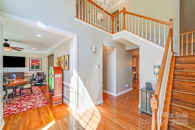 15811 Burlingame Dr, Huntersville, NC 28078 - foyer entrance with a ceiling fan, ornamental molding, light wood finished floors, stairway, and recessed lighting