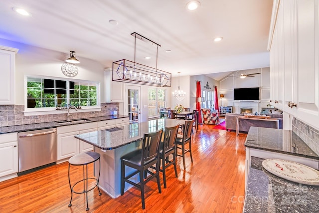 15811 Burlingame Dr, Huntersville, NC 28078 - kitchen featuring dishwasher, white cabinetry, decorative backsplash, a fireplace, and recessed lighting