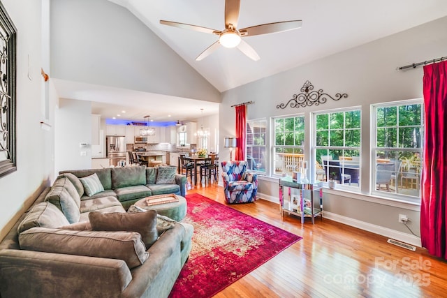 15811 Burlingame Dr, Huntersville, NC 28078 - living room featuring high vaulted ceiling, a ceiling fan, plenty of natural light, and light wood finished floors