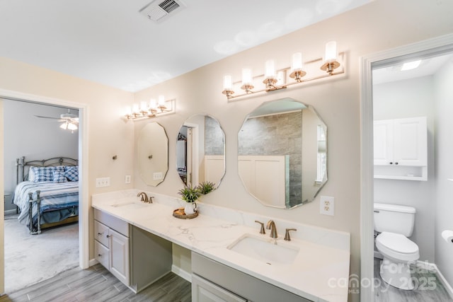 15811 Burlingame Dr, Huntersville, NC 28078 - ensuite bathroom featuring double vanity, wood finished floors, and a ceiling fan
