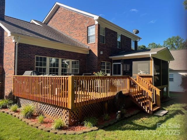 15811 Burlingame Dr, Huntersville, NC 28078 - rear view of property featuring a sunroom, brick siding, a deck, and a yard