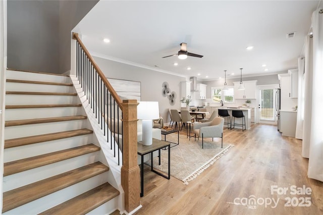 2003 Ashley Rd Unit B, Charlotte, NC 28208 - living room featuring ceiling fan, stairway, crown molding, light wood-style floors, and recessed lighting