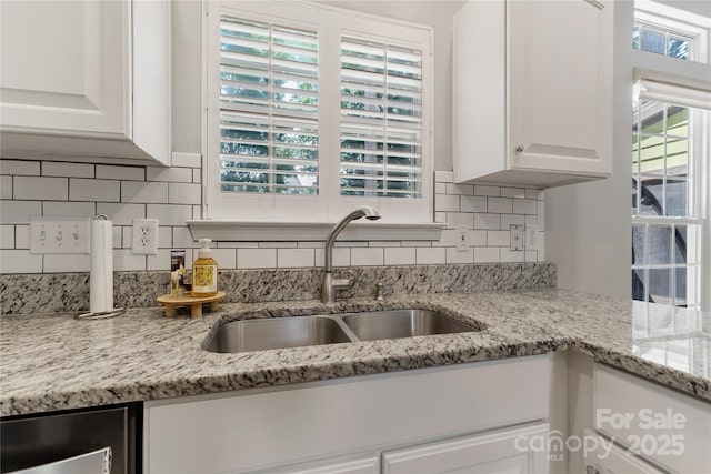 4000 Garfield Ct, Waxhaw, NC 28173 - kitchen featuring white cabinetry, backsplash, and light stone counters