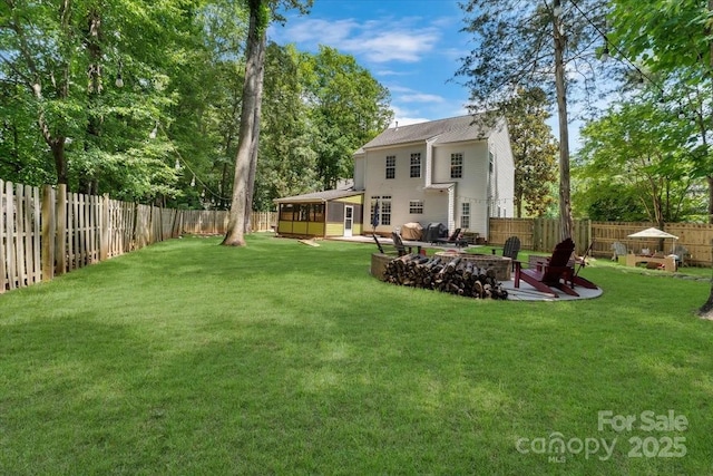 4000 Garfield Ct, Waxhaw, NC 28173 - fenced backyard featuring a fire pit, a patio, and a sunroom