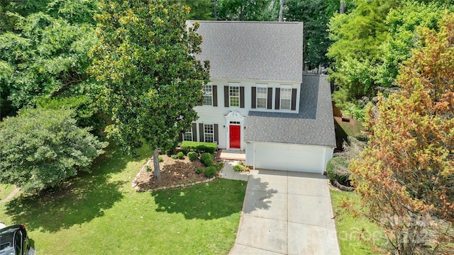 4000 Garfield Ct, Waxhaw, NC 28173 - colonial house featuring roof with shingles, a garage, concrete driveway, and a front lawn