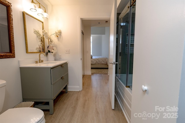 720 Governor Morrison St Unit 221, Charlotte, NC 28211 - ensuite bathroom featuring wood finished floors, vanity, and enclosed tub / shower combo