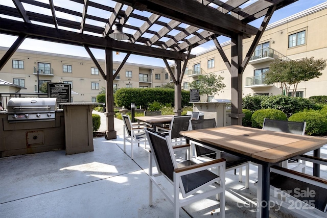 720 Governor Morrison St Unit 221, Charlotte, NC 28211 - view of patio featuring outdoor dining area, a pergola, and exterior kitchen