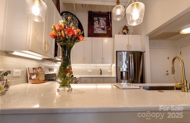 720 Governor Morrison St Unit 221, Charlotte, NC 28211 - kitchen with stainless steel refrigerator with ice dispenser, backsplash, and white cabinets
