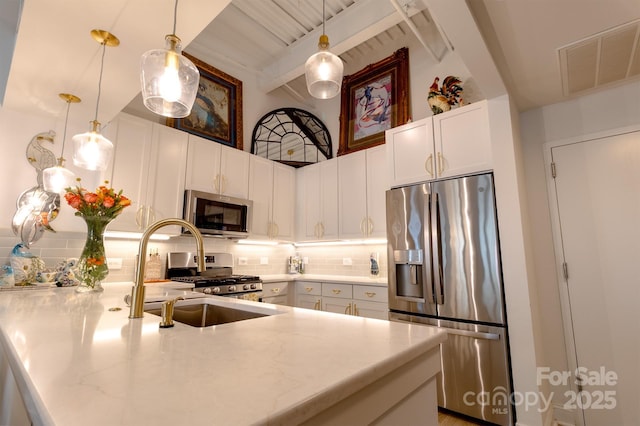 720 Governor Morrison St Unit 221, Charlotte, NC 28211 - kitchen featuring stainless steel appliances, a peninsula, beam ceiling, tasteful backsplash, and white cabinets