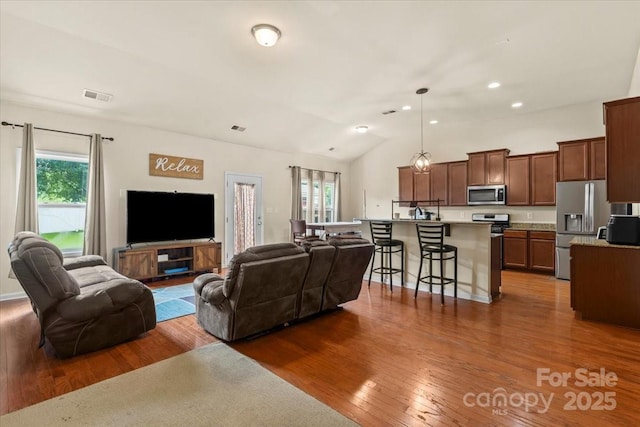 5111 Elementary View Dr, Charlotte, NC 28269 - living room with dark wood-style floors, lofted ceiling, and recessed lighting