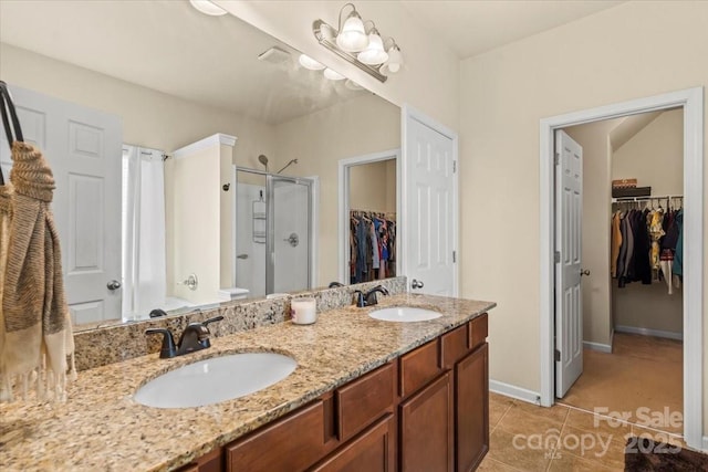 5111 Elementary View Dr, Charlotte, NC 28269 - bathroom with a spacious closet, a shower stall, double vanity, and tile patterned floors