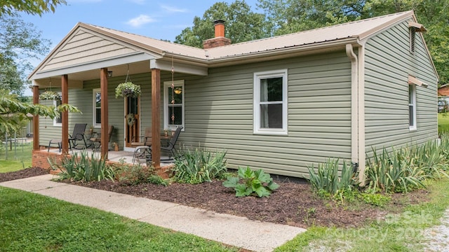 3980 English Oak Dr, Lincolnton, NC 28092 - view of front of house featuring a porch, a metal roof, and a chimney