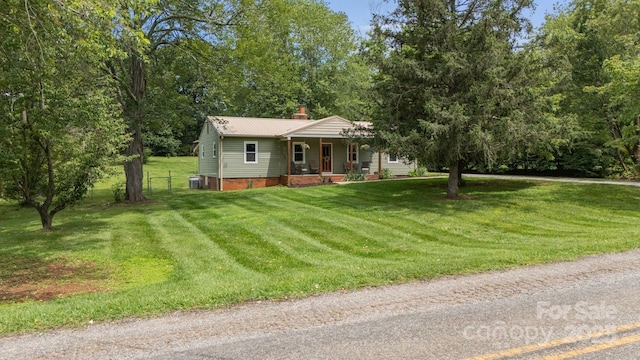3980 English Oak Dr, Lincolnton, NC 28092 - view of front facade with a porch, a front yard, a chimney, and a metal roof
