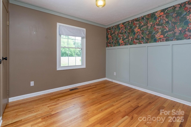 46 Dixon Ter Unit 12, Candler, NC 28715 - unfurnished room with light wood-style floors, wainscoting, a decorative wall, and ornamental molding