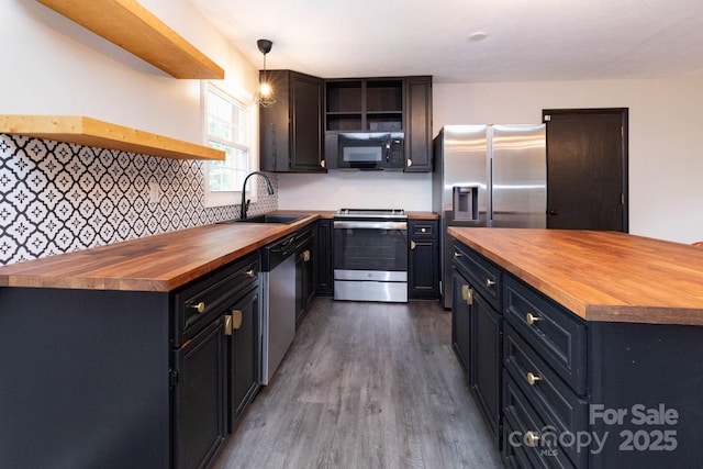 46 Dixon Ter Unit 12, Candler, NC 28715 - kitchen with butcher block counters, open shelves, appliances with stainless steel finishes, dark wood-style floors, and decorative backsplash