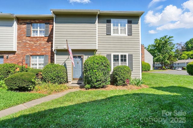 6044 Heath Valley Rd, Charlotte, NC 28210 - townhome / multi-family property with a front lawn and brick siding
