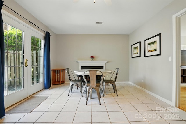 6044 Heath Valley Rd, Charlotte, NC 28210 - dining space with french doors, light tile patterned floors, baseboards, a fireplace, and ceiling fan