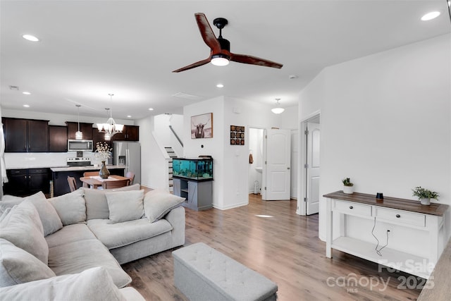 112 Aspire Cir, Wingate, NC 28174 - living area with stairway, a chandelier, recessed lighting, light wood-type flooring, and ceiling fan