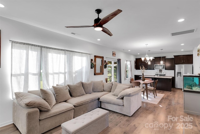 112 Aspire Cir, Wingate, NC 28174 - living area featuring recessed lighting, light wood-style flooring, ceiling fan, and a chandelier