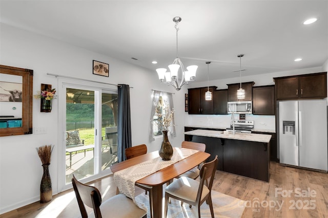 112 Aspire Cir, Wingate, NC 28174 - dining room with light wood-style flooring, a chandelier, and recessed lighting