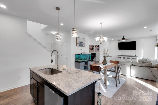 112 Aspire Cir, Wingate, NC 28174 - kitchen featuring stainless steel dishwasher, open floor plan, light wood-type flooring, a ceiling fan, and hanging light fixtures