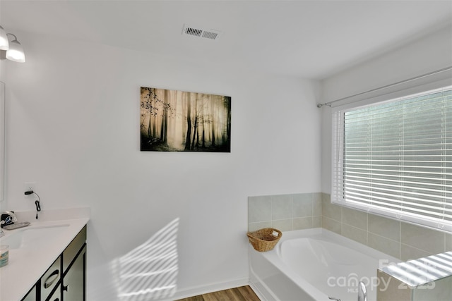 112 Aspire Cir, Wingate, NC 28174 - bathroom featuring a bath, vanity, and wood finished floors