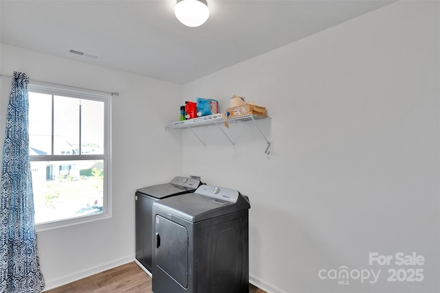 112 Aspire Cir, Wingate, NC 28174 - laundry room with healthy amount of natural light, wood finished floors, and washing machine and clothes dryer