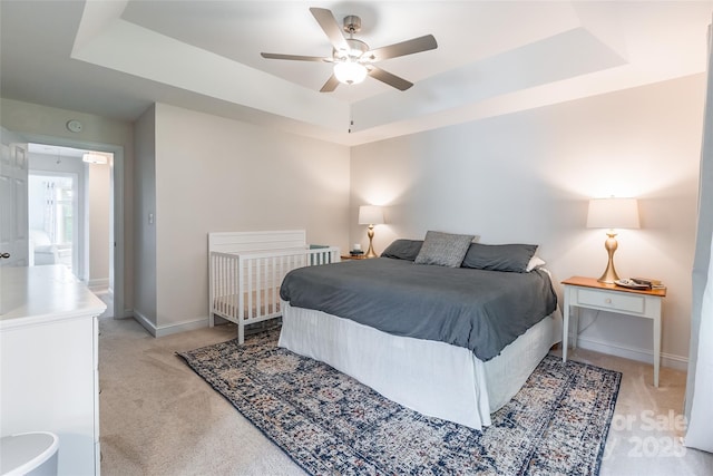 2079 Audubon Dr, Rock Hill, SC 29732 - bedroom with a tray ceiling, light carpet, baseboards, and a ceiling fan