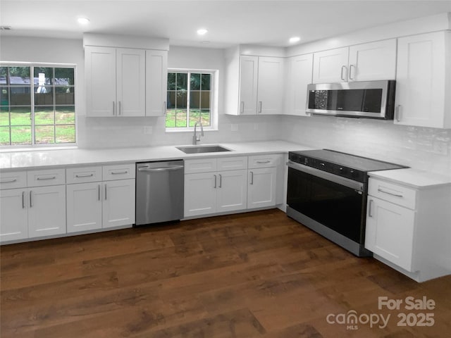 7134 Rollingridge Dr, Charlotte, NC 28211 - kitchen with stainless steel appliances, a sink, white cabinets, backsplash, and recessed lighting