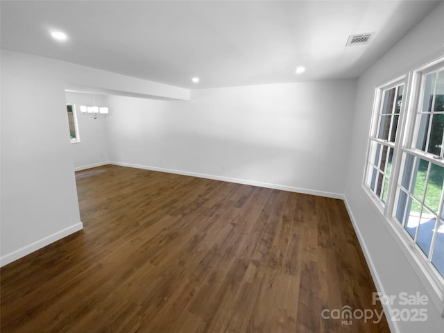 7134 Rollingridge Dr, Charlotte, NC 28211 - empty room with baseboards, dark wood-style flooring, a chandelier, and recessed lighting