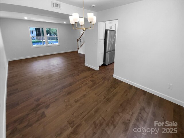 7134 Rollingridge Dr, Charlotte, NC 28211 - unfurnished dining area featuring a chandelier, baseboards, and dark wood finished floors
