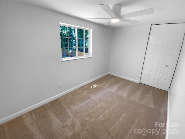 7134 Rollingridge Dr, Charlotte, NC 28211 - unfurnished bedroom with carpet floors, a closet, baseboards, and ceiling fan
