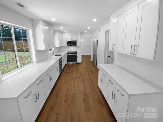 7134 Rollingridge Dr, Charlotte, NC 28211 - kitchen featuring appliances with stainless steel finishes, a sink, dark wood-style flooring, recessed lighting, and tasteful backsplash