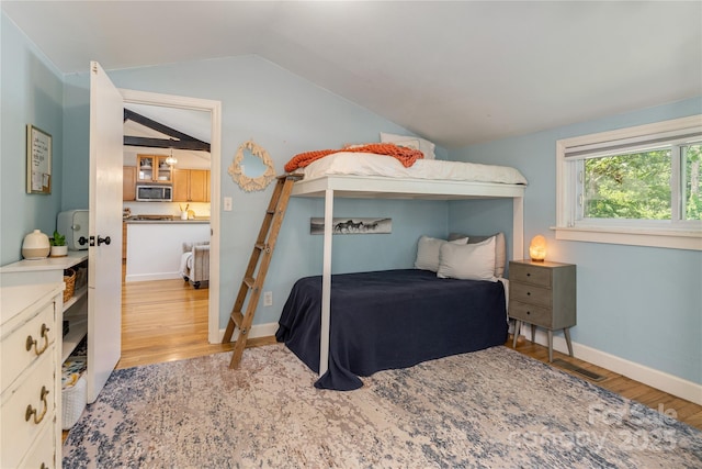 540 Oak Grove Rd, Flat Rock, NC 28731 - bedroom with vaulted ceiling and light wood-style flooring