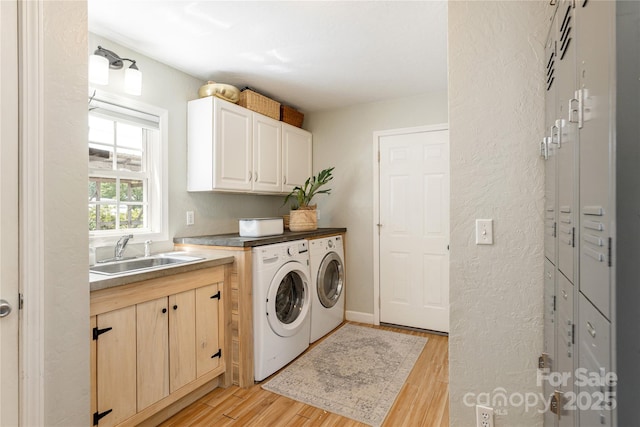 540 Oak Grove Rd, Flat Rock, NC 28731 - laundry area with washing machine and dryer, light wood-style flooring, and cabinet space
