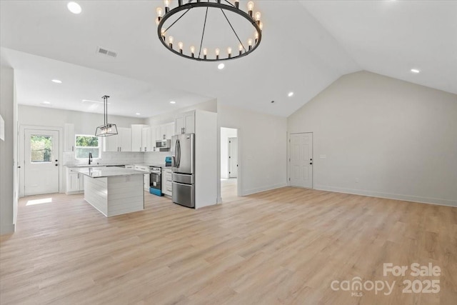5526 Brookwood Ln, Hickory, NC 28602 - kitchen featuring stainless steel appliances, light countertops, a chandelier, a center island, and lofted ceiling