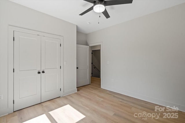 5526 Brookwood Ln, Hickory, NC 28602 - unfurnished bedroom with light wood-type flooring, a closet, and a ceiling fan
