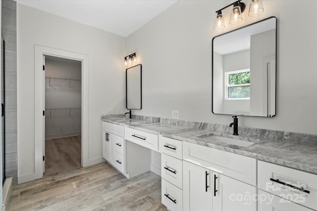 5526 Brookwood Ln, Hickory, NC 28602 - full bathroom featuring double vanity, wood finished floors, and a walk in closet