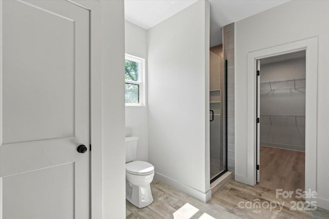 5526 Brookwood Ln, Hickory, NC 28602 - bathroom with wood finished floors, a stall shower, and a walk in closet