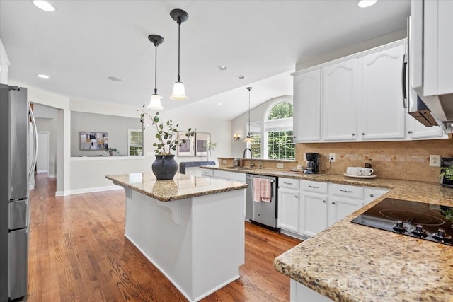 110 Isle Run Dr, Mooresville, NC 28117 - kitchen with appliances with stainless steel finishes, lofted ceiling, white cabinets, pendant lighting, and light wood-style flooring